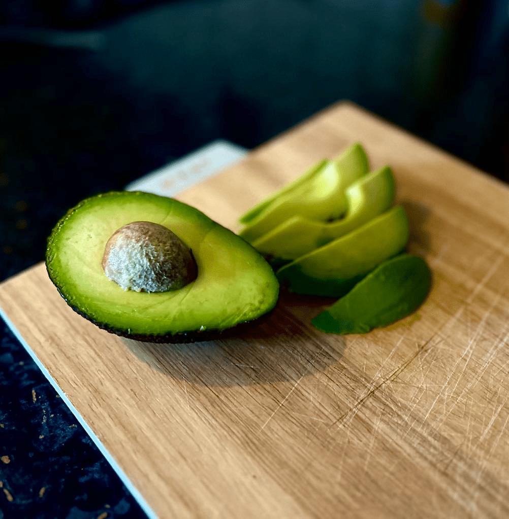 avocado on wooden chopping board