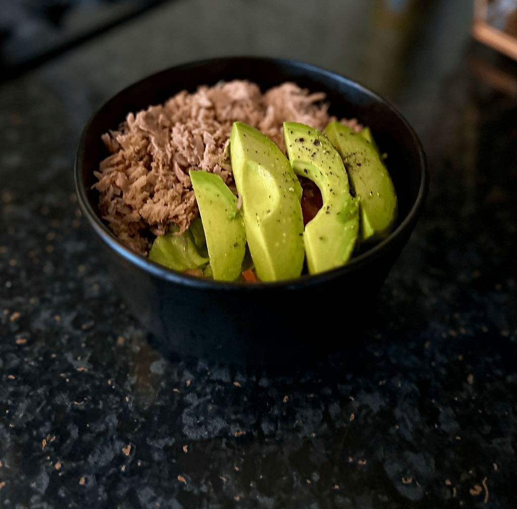 tuna salad with avocado in black bowl, nutritious, delicious